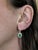 A true celebration of color and light, these earrings feature vivid oval Zambian emeralds surrounded by a starburst of...