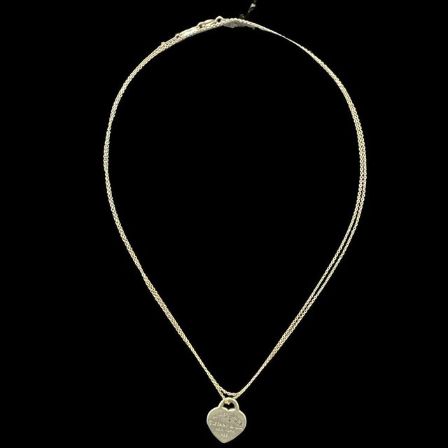 Authentic Tiffany & Co. vintage heart tag necklace crafted in solid sterling silver. The iconic “Please Return to Tiffany...