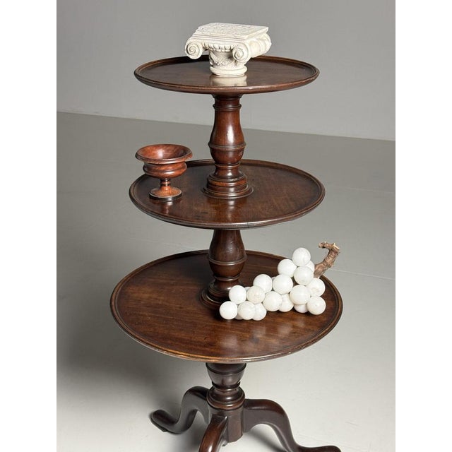 Particularly beautiful English 19th century tripod etagère table. Very suitable for use in shops to present items....