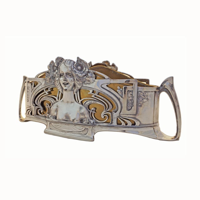 Antique silverplate jardiniere complete with its original fitted bronzed copper liner. Each side of the jardiniere is...