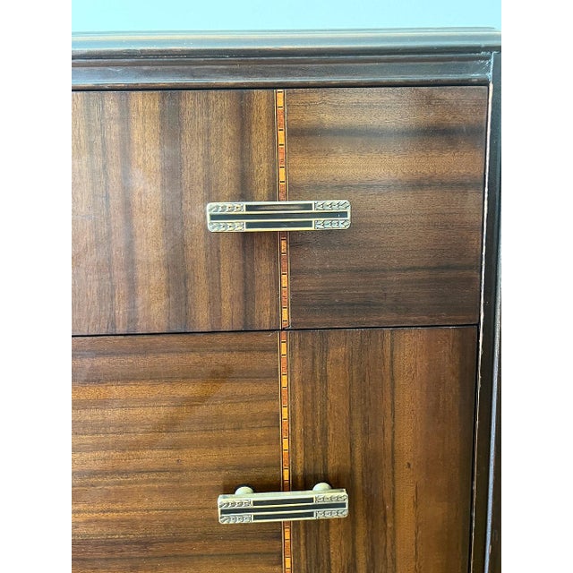This American vintage late 1930s walnut dresser features beautiful figured walnut drawer fronts and striking Deco-...