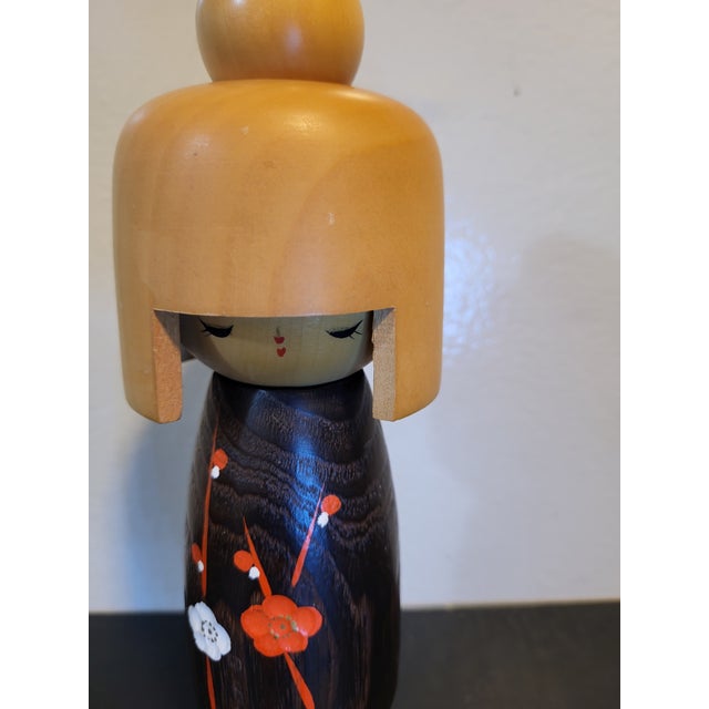 A tall vintage Japanese wood kokeshi doll. Lovely hand painted floral pattern. Nice two tone detailing with the blonde...