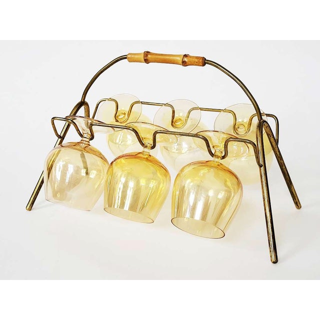 Lovely modernist cognac glass stand handmade in the 1950s in the style of Carl Auböck, made of solid brass with a shapely...