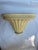 A single vintage curved faux wood wall bracket or shelf featuring a faux wood grain finish.