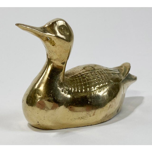 Vintage brass duck figure with detailed wings and upturned head. For use as paper weight or decorative object. Heavy,...