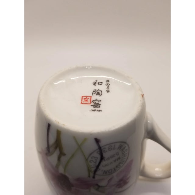 A beautiful cup with pictures of orchids and made of porcelain, vintage.