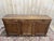Empire period walnut sideboard with three doors and three drawers. Good overall condition.