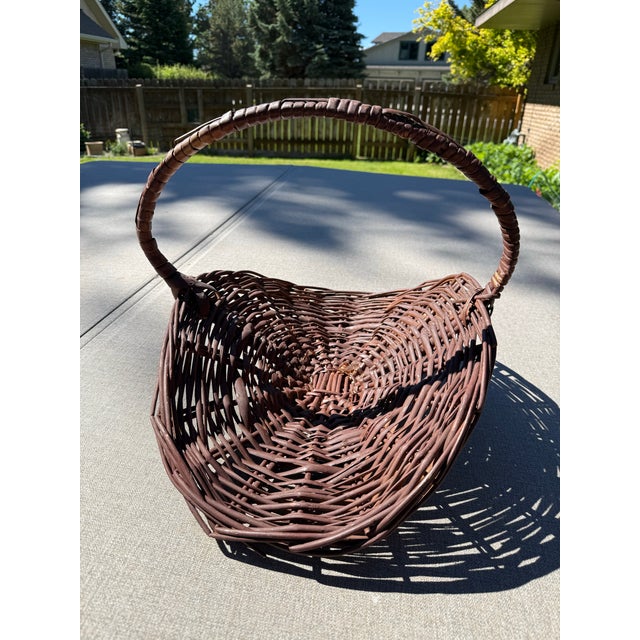 Beautiful vintage French-style wicker flower basket with a striking arched structure typically used for gathering flowers...