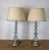 A sublime and highly coveted pair of vintage Hollywood Regency table lamps composed of stacked graduated rock crystal...
