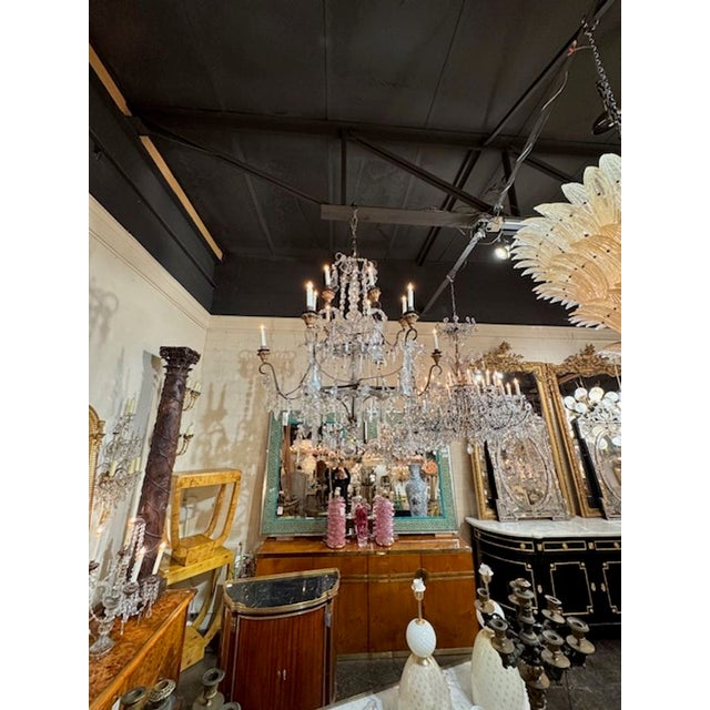 Large scale 19th century Italian iron, crystal and giltwood 14-light chandelier. Circa 1880. The chandelier has been...