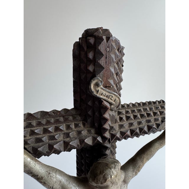 A powerful and soulful antique tramp-art crucifix, hand-carved in the classic layered chip-carving style, featuring...