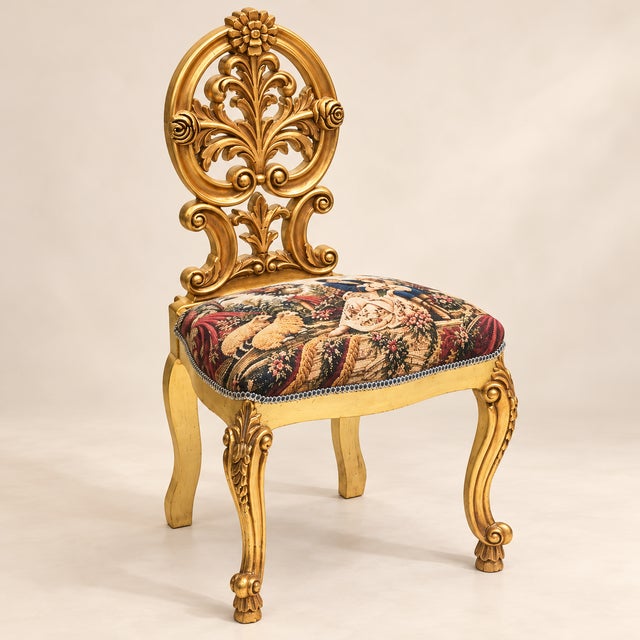 Make a statement with this exquisite Rococo-inspired accent chairs, featuring intricately sculpted gold leaf frames,...