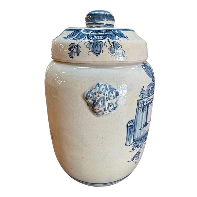 Hand painted Spanish apothecary tabac jar, circa 1900. Painted with a mask/cherub cartouche with a radiating floral...