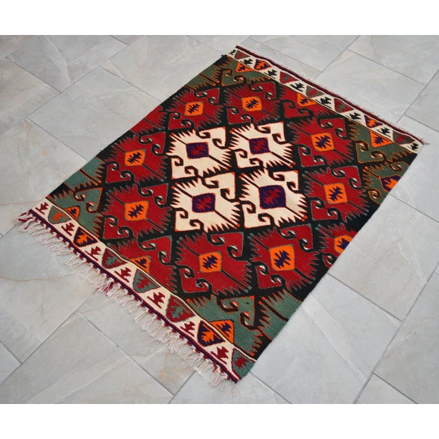 This is a vintage Villager Made Turkish Kilim rug made from wool on cotton. The rug is in excellent vintage condition with...