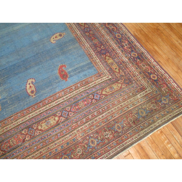 Unique Persian Doroksh carpet with multiple boteh motifs on a solid sky blue ground encased by multiple borders. Antique...
