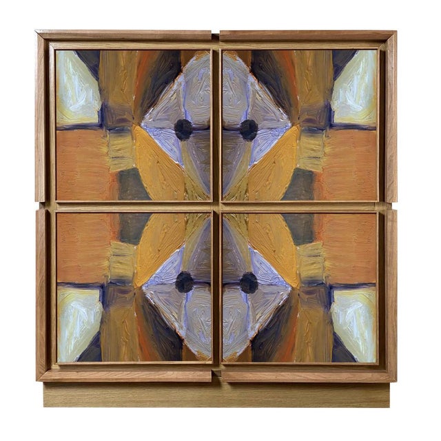 Oak sideboard with cherry frames and walnut details. Divided into four spaces with internal shelves, it has four doors...