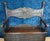 Solid wood storage bench in the Italian Renaissance style, decorated with grimacing masks. Features Gothic-style...