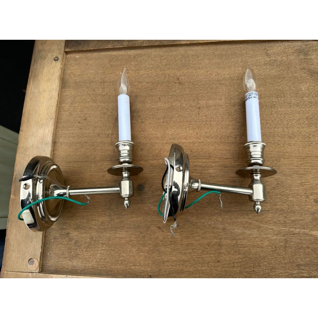 A pair of french library single arm wall sconces in a polished nickel finish. Photographed on a table 24" deep for scale....