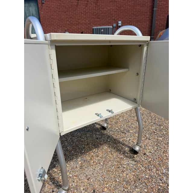 Exceptional pair of original 1950s Medco-Sonlator medical storage cabinets, showcasing the streamlined industrial design...