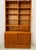 Sculptural Danish teak wall unit by Hundevad & Co., Denmark, dating to the 1990s, combining open bookshelf storage, a...