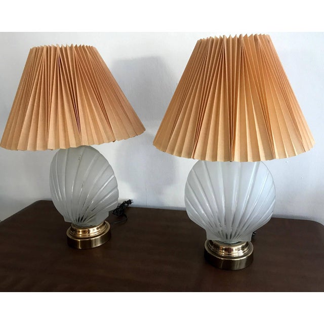 Very groovy and retro, this pair of table lamps features a frosted glass urn in a molded seashell form on polished brass...