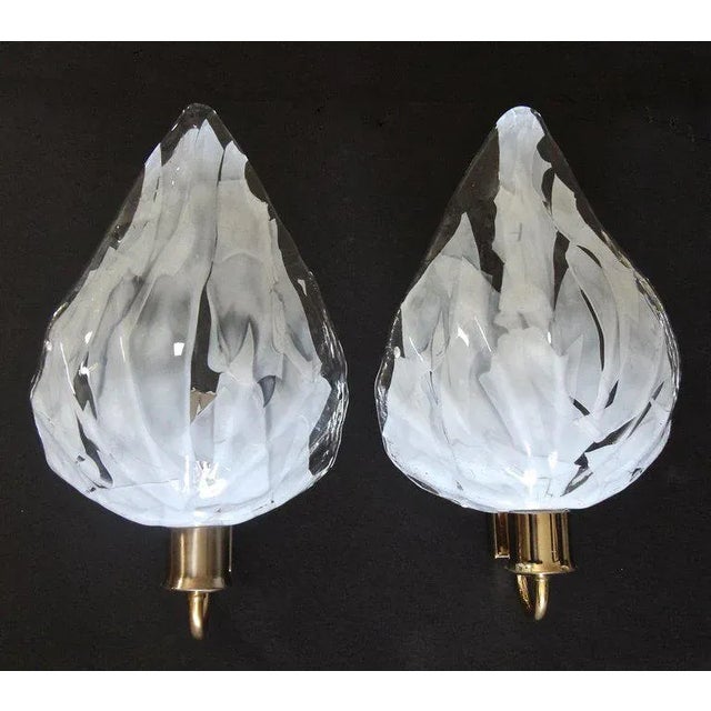 Pair of La Murrina Italian handblown clear and white leaf-shaped wall sconces mounted on brass wall plates. Newly wired...