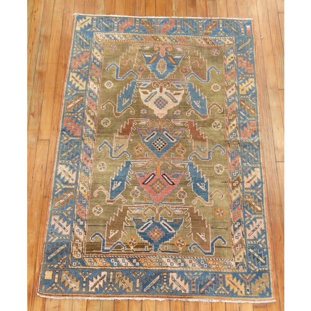 A fine example of camel field Caucasian Rug. Shades of denim blue and orange sprinkled in 3'4" x 5'3"