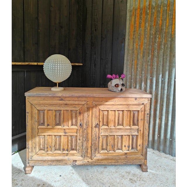 Late 19th-century low sideboard with two doors, made of solid pine with a chestnut top. Beautiful patina; it has been...