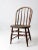 This classic Windsor chair features a bowed spindle back and a charming splattering of white paint. A perfect addition to...