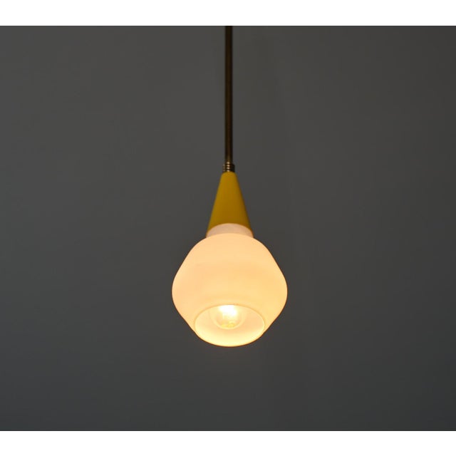 Italian midcentury ceiling pendant light, crafted in the 1950s with a fusion of timeless elegance and modern design. This...