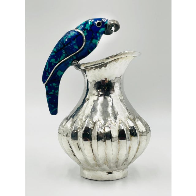 Whimsical silver-plated water pitcher designed and handcrafted in the 1960s by the renowned Los Fajardo workshop of Taxco,...