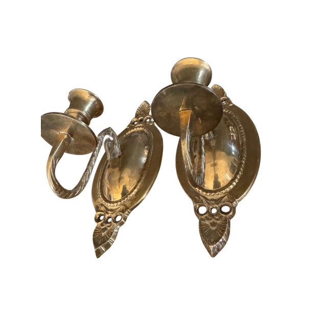 Add timeless warmth and vintage elegance to your walls with this beautiful pair of solid cast brass candle wall sconces....