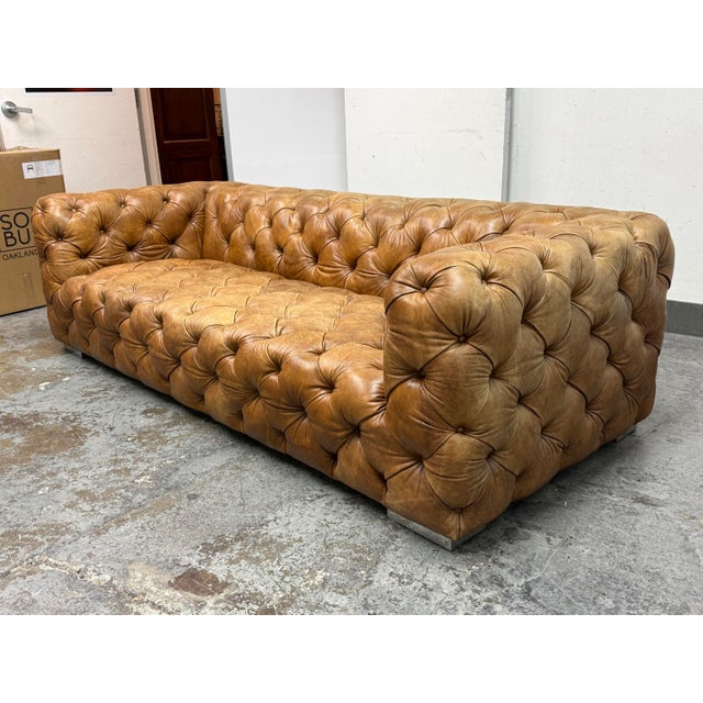 Design Plus Gallery presents a Chesterfield Sofa in Saddle Brown Leather. This heavily button-tufted chesterfield sofa is...