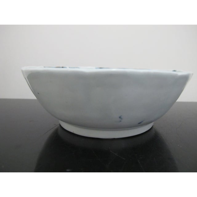 Chinese porcelain bowl in blue and white with village mountain scene and scalloped rim. Measures 6" x 2" tall . Excellent...