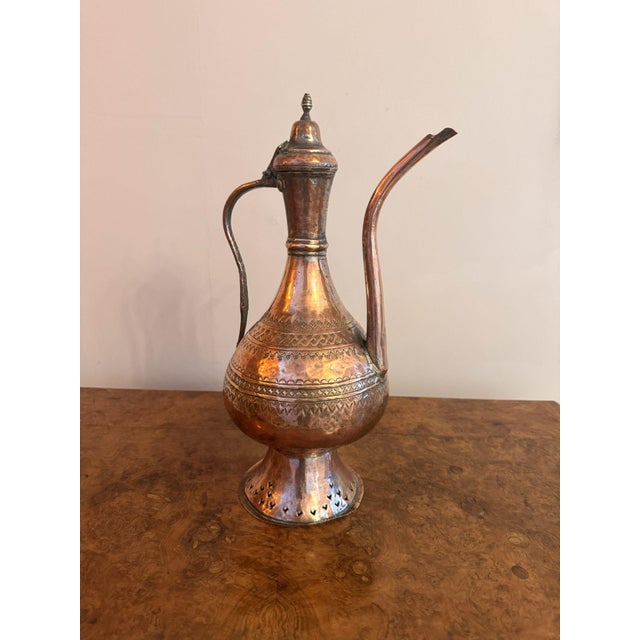 Quality 19th Century antique Middle Eastern copper coffee pot, having a quality 19th century copper coffee pot with a...