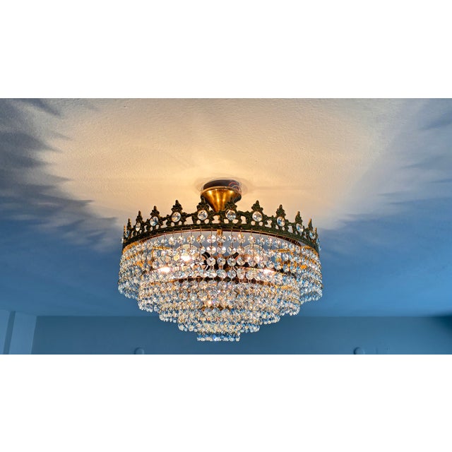 Bring a touch of mid-century royalty into your modern home with this spectacular 1960s antique crown crystal chandelier....