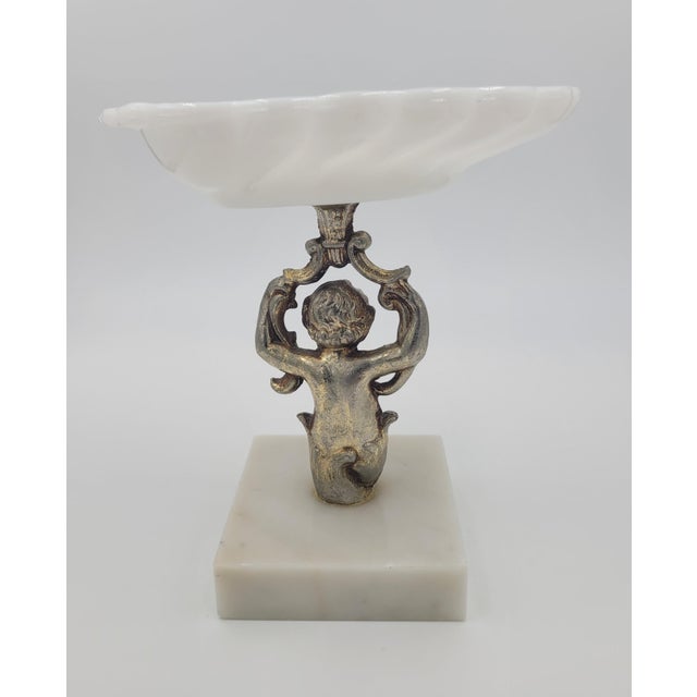 Add a touch of whimsical elegance to your tabletop or vanity with this vintage Hollywood Regency pedestal dish. This...