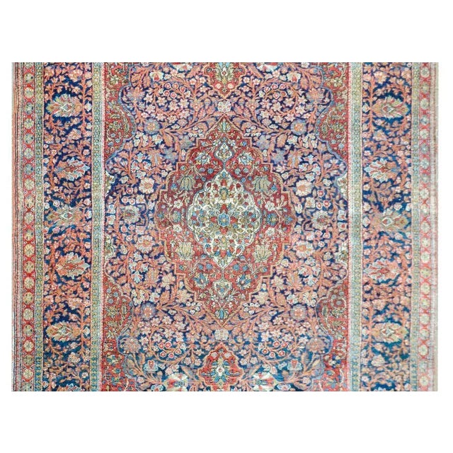 A fantastic early 20th century Persian Kashan rug with a mesmerizing pattern with a large central medallion filled with...