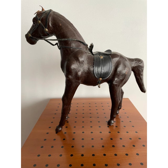 This impressively realistic vintage horse is made of wood, and features leather accessories. Careful attention has been...