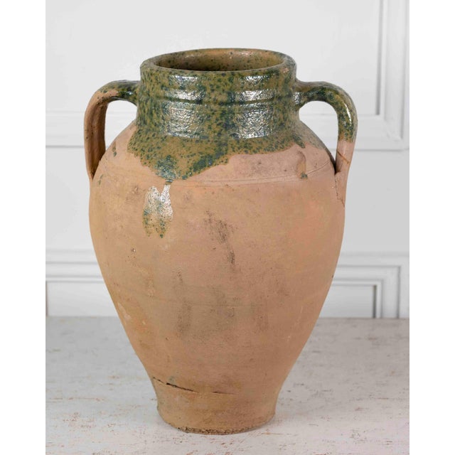 Made in Turkey around 1900, this water pot is finished in a green glaze. Vessels of this kind were practical containers...