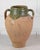 Made in Turkey around 1900, this water pot is finished in a green glaze. Vessels of this kind were practical containers...