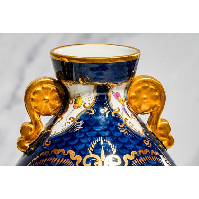 A captivating example of late 19th-century English porcelain artistry, this pair of Victorian vases from the esteemed...
