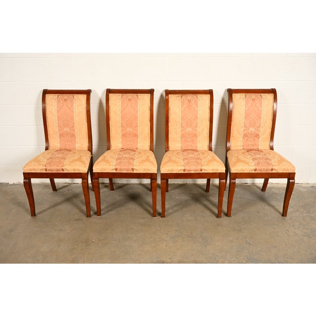 A gorgeous set of four Regency or Neoclassical style dining chairs In the manner of Baker Furniture USA, Circa 1980s...