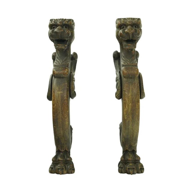 Dark tone solid pine figures carved into griffins. Good condition with appropriate wear from age. Priced as a pair. The...