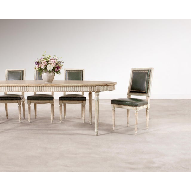 A handsome set of six French painted dining chairs crafted in the grand Louis XVI taste. The chairs are hand-crafted from...