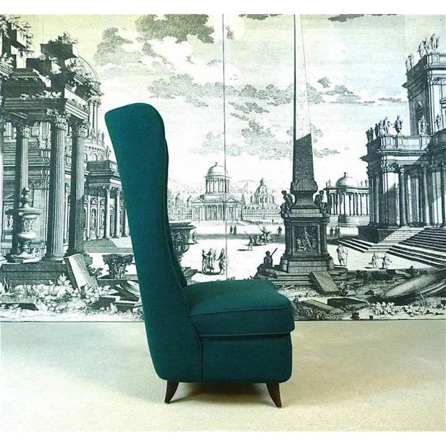 The Slipper Chair was designed by Paolo Buffa in the early 1950s. It features a high-back buttoned backrest upholstered in...