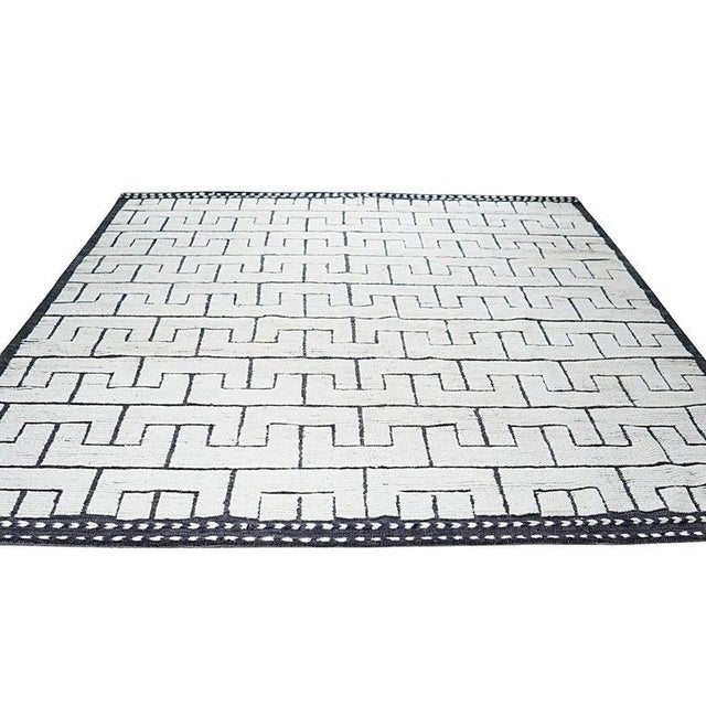 This hand knotted pile rug features a primary color palette of ivory, beige, cream, and white. Crafted from wool, this...