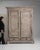 Painted oak armoire in Weathered Pale Grey. Its weathered pale grey finish sets off raised panel doors, bun feet, softly...