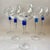 A striking set of 6 vintage wine glasses featuring clear bowls and elegant stems with an integrated cobalt blue beehive...