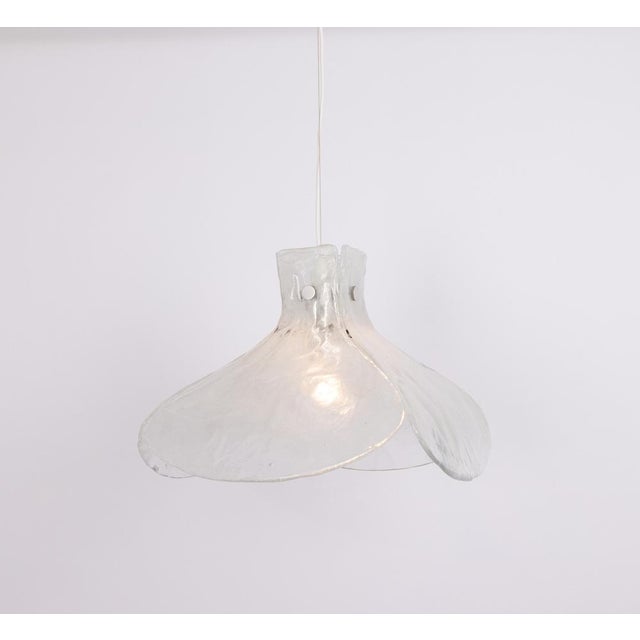 A stunning large murano white glass chandelier designed by kalmar, austria manufactured in the 1960s. The chandelier is...
